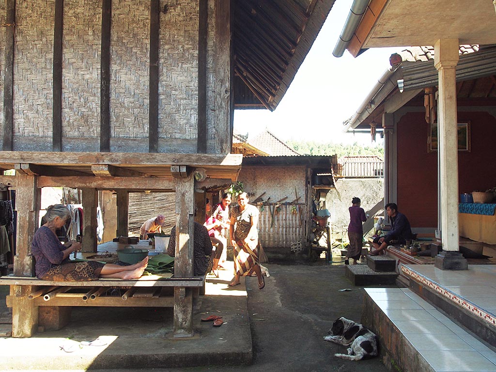 米倉の下で供物を制作する女性たち